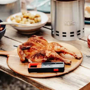 herQs langaton lämpömittari puulaudalla grillatun kanan vierellä tarkkaa grillilämpötilaa varten